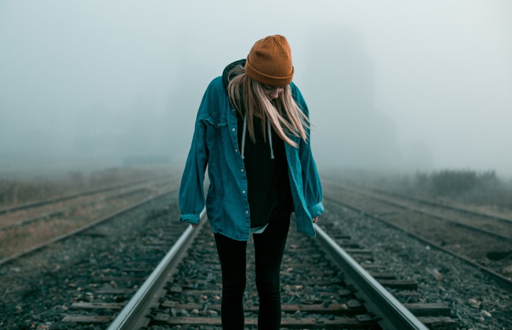 negative-space-woman-raliway-tracks-hat-shirt-rain-elliott-chau